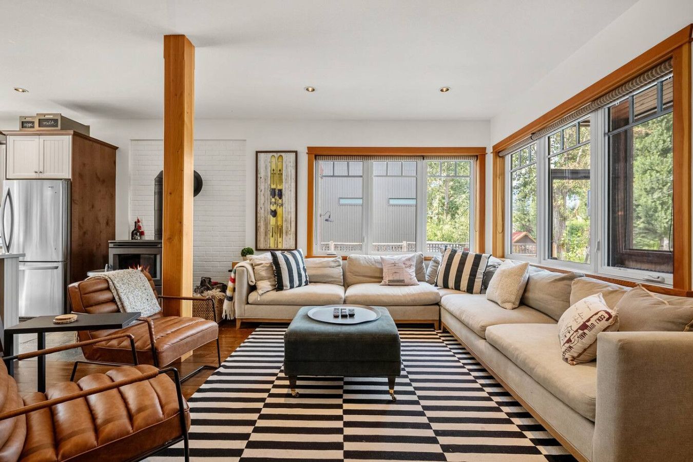 A living room with a couch and chairs and a view of the city