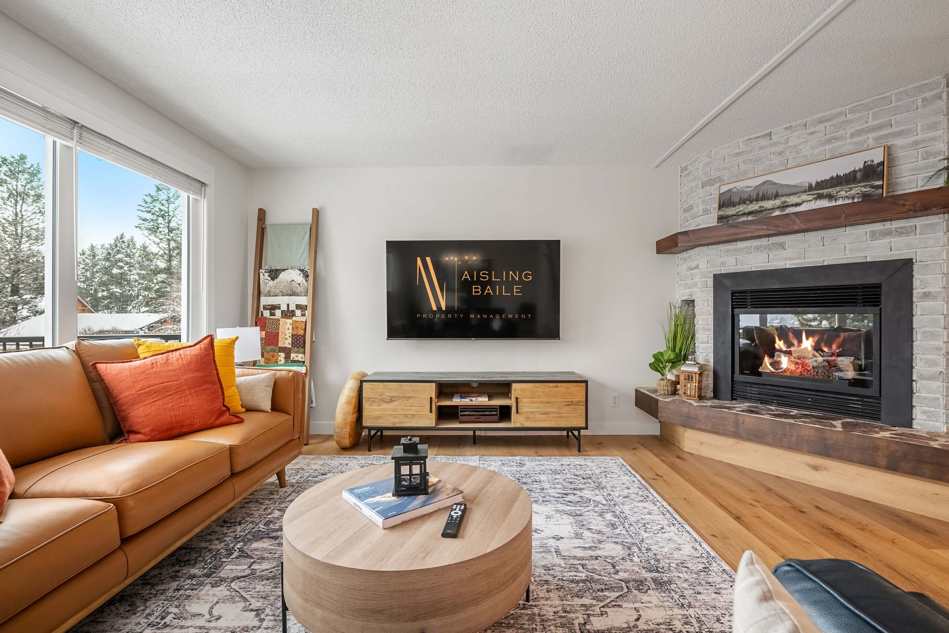 A living room with a couch and chairs and a fireplace.