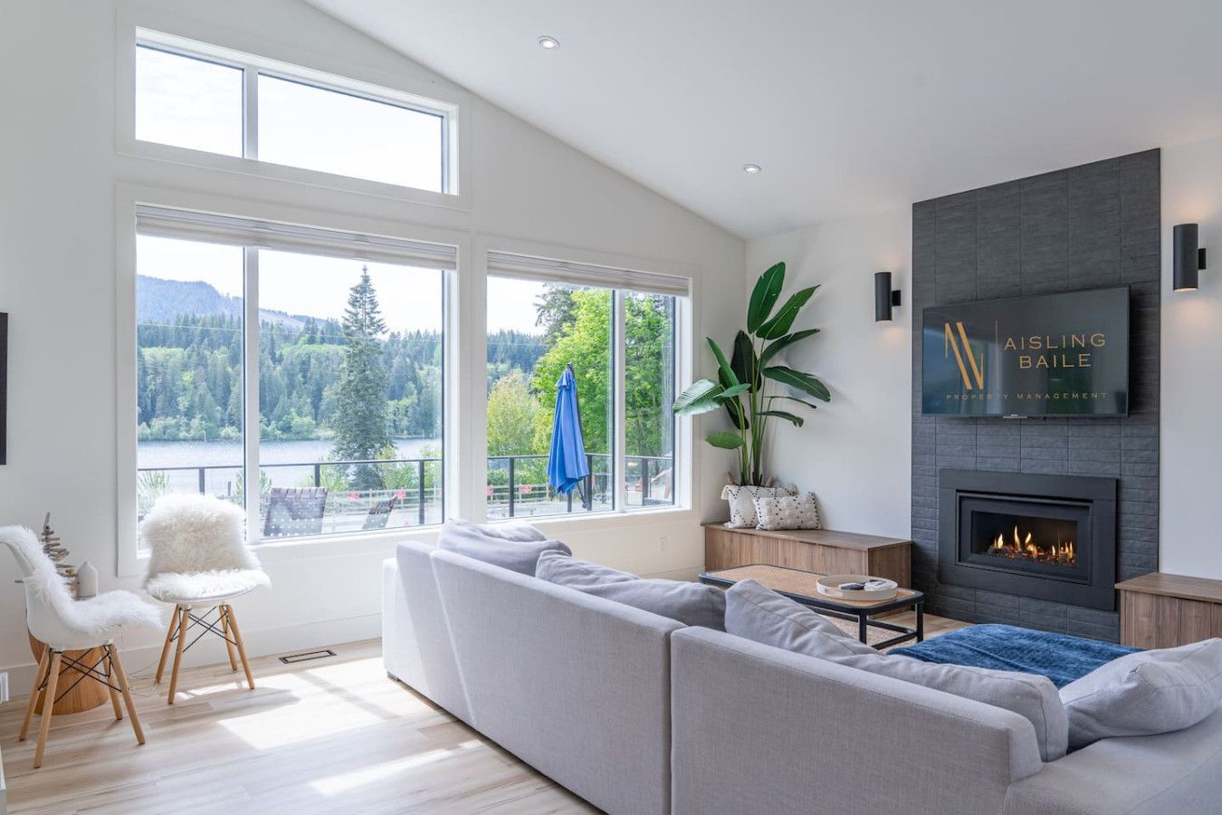 Living room with a fireplace and views of lake cowichan.
