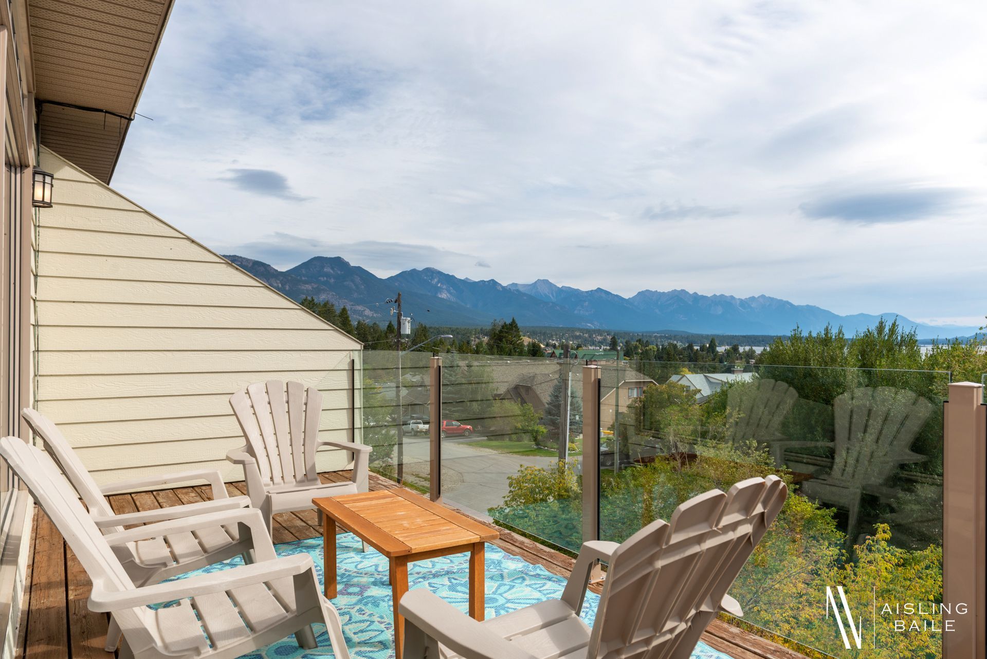 Private patio with lake and mountain views from Central Elegance, an Invermere BC Vacation Rental hosted by Aisling Baile Property Management.