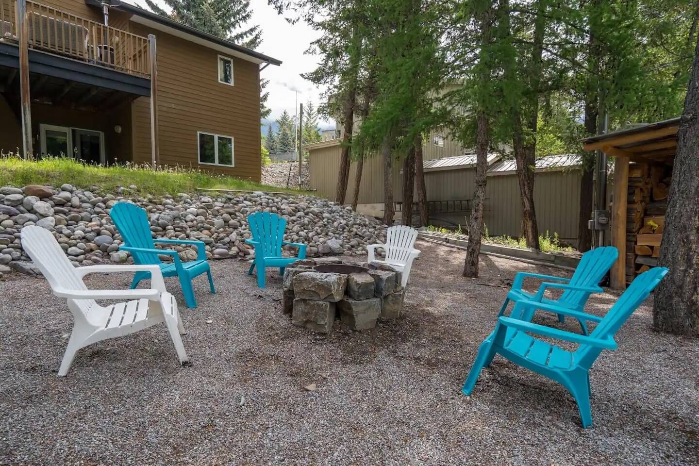 Outdoor playground and fire pit of Tranquil Pines, a Fairmont Hot Springs BC Vacation Rental hosted by Aisling Baile Property Management.