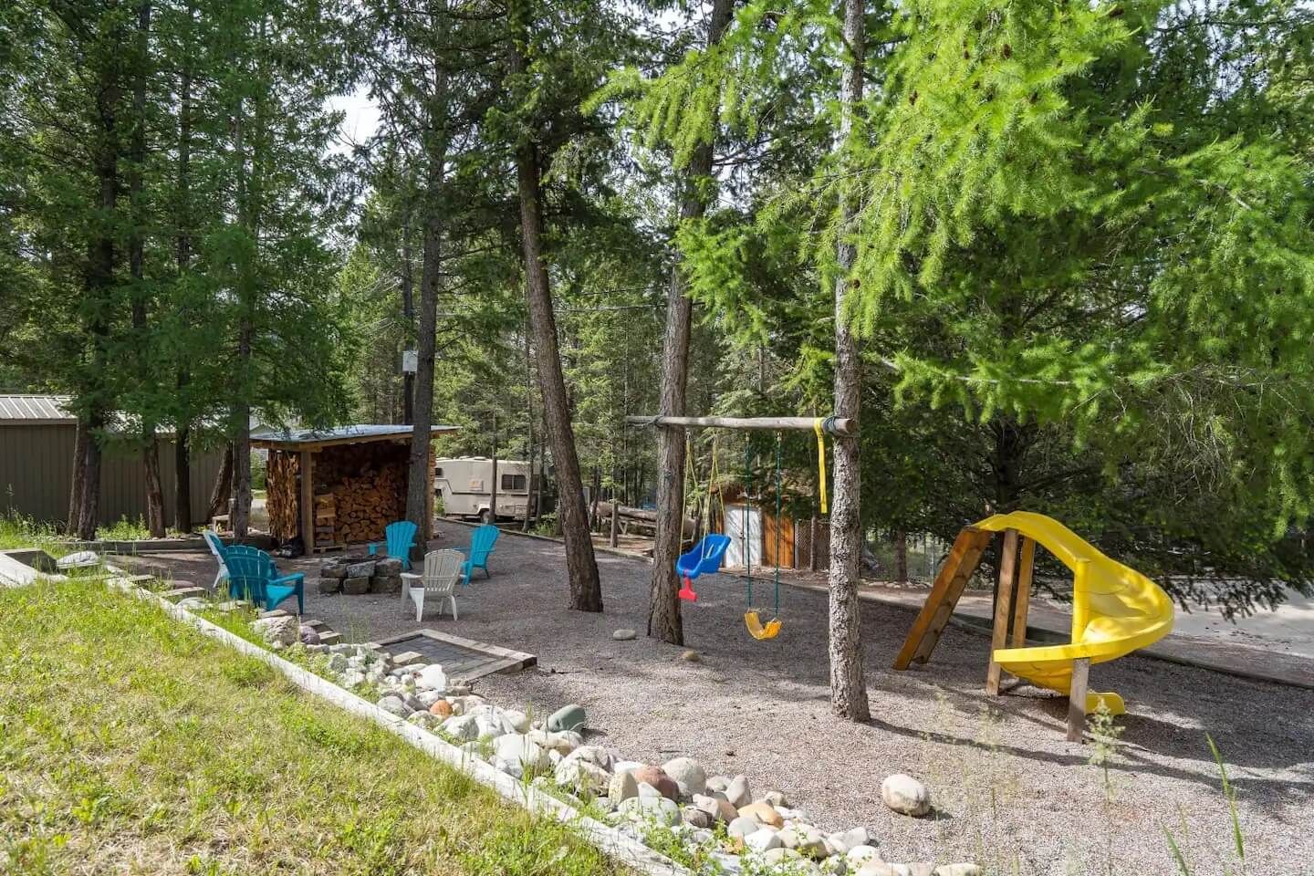 Outdoor playground and fire pit of Tranquil Pines, a Fairmont Hot Springs BC Vacation Rental hosted by Aisling Baile Property Management.