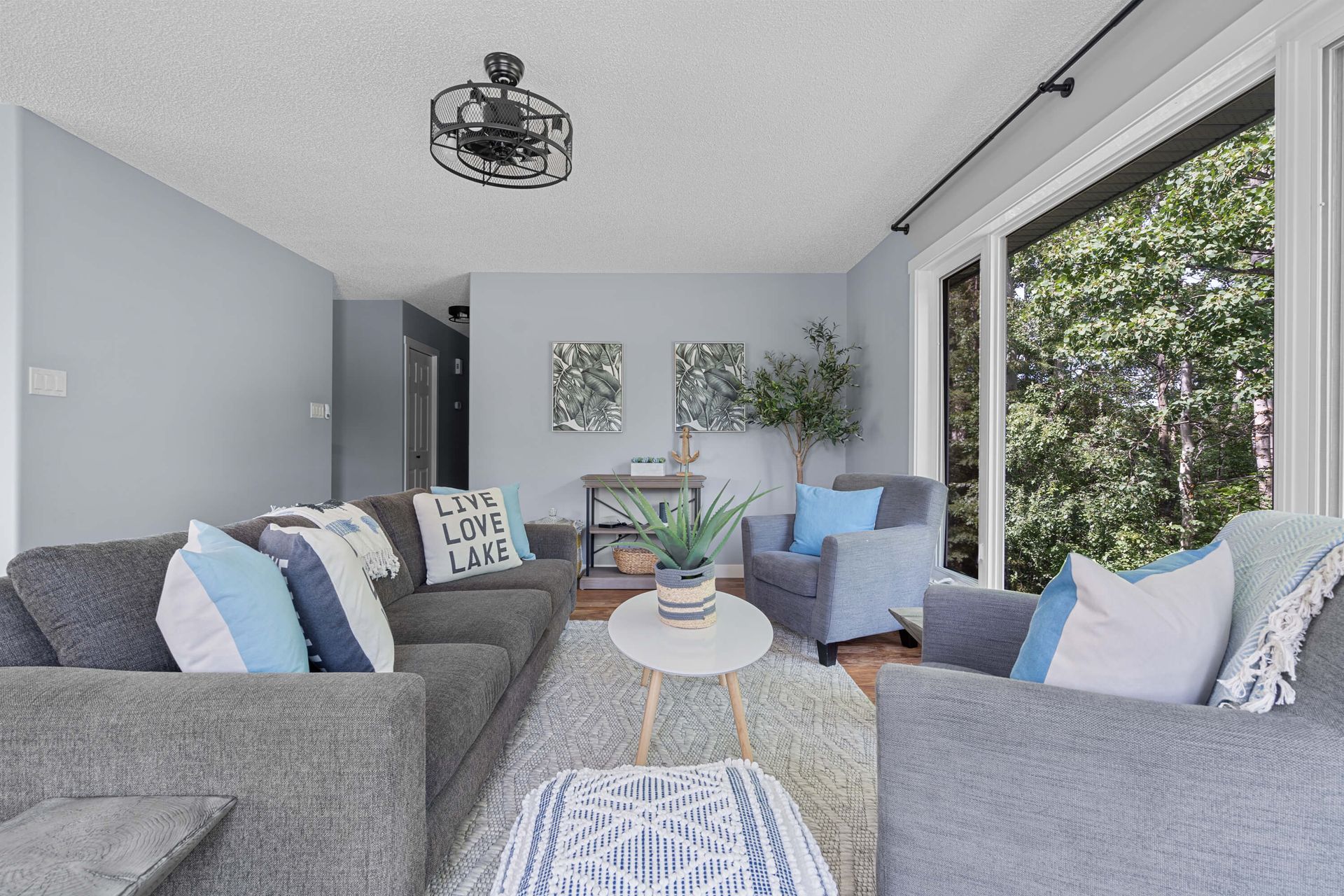 A living room filled with furniture and a ceiling fan.