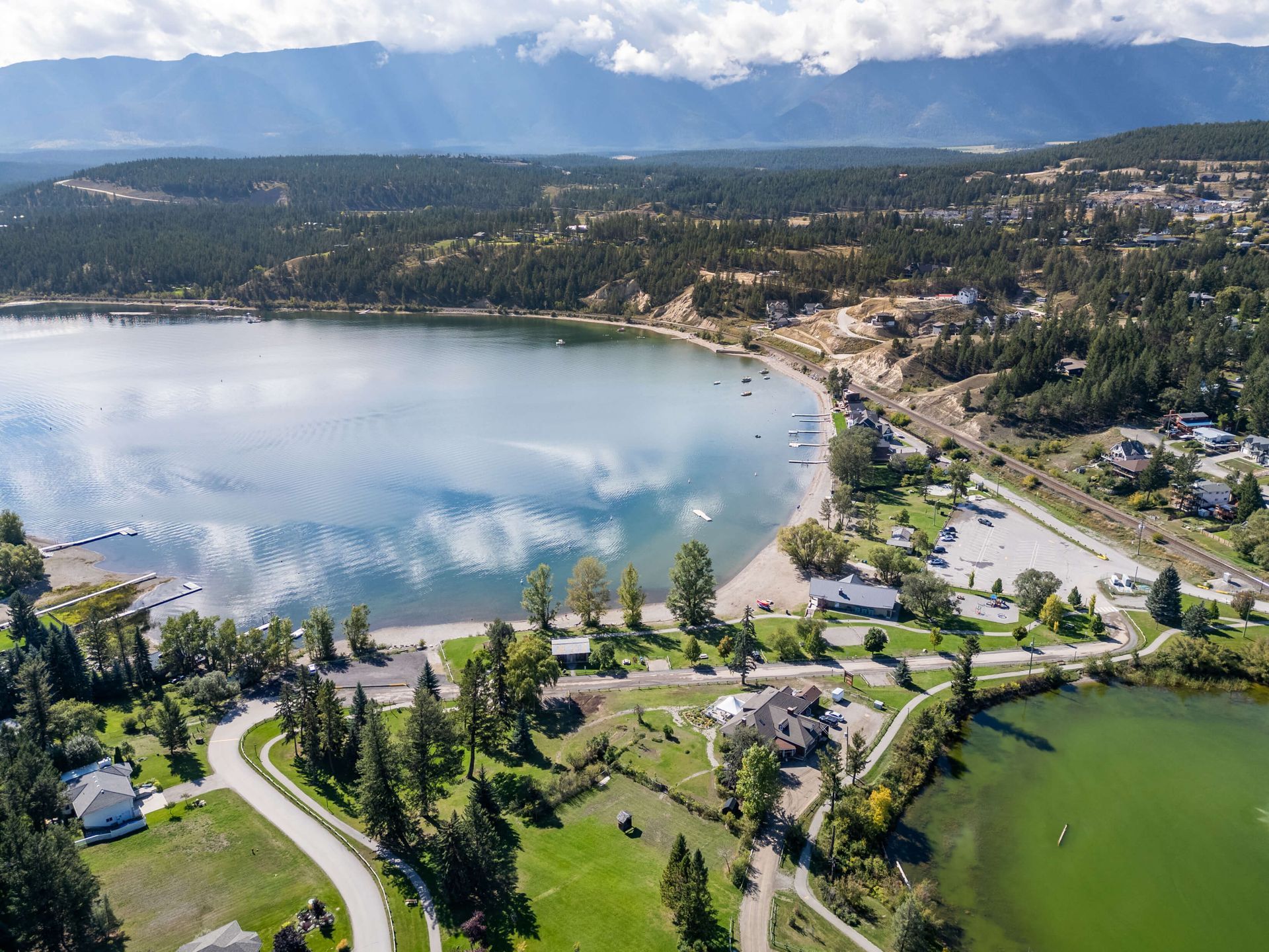 A living room with a couch , chair , coffee table and rug.