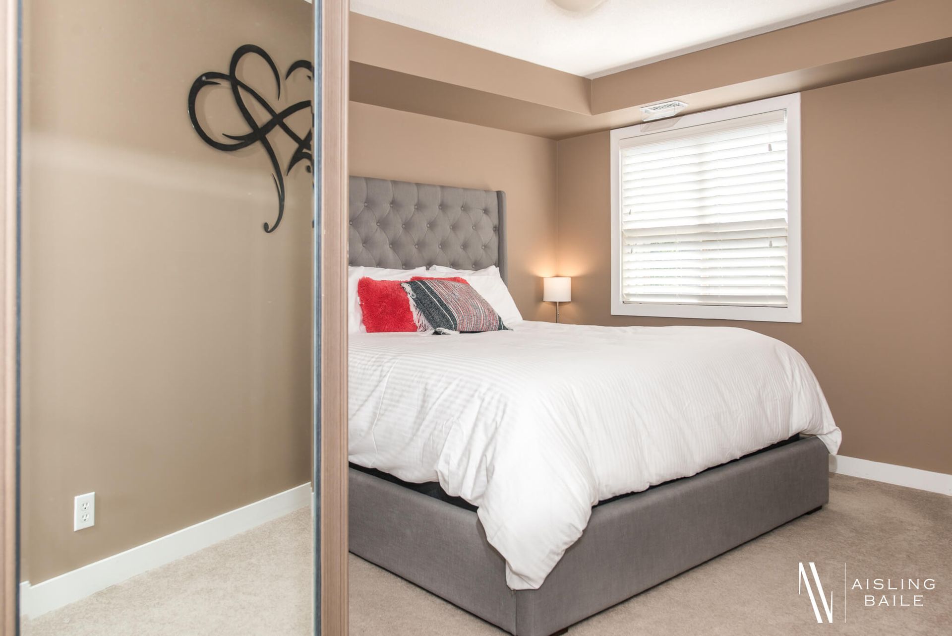 Primary bedroom with a king bed at the Stylish condo of Lake Windermere Pointe in Invermere, a BC Vacation Rental hosted by Aisling Baile Property Management.