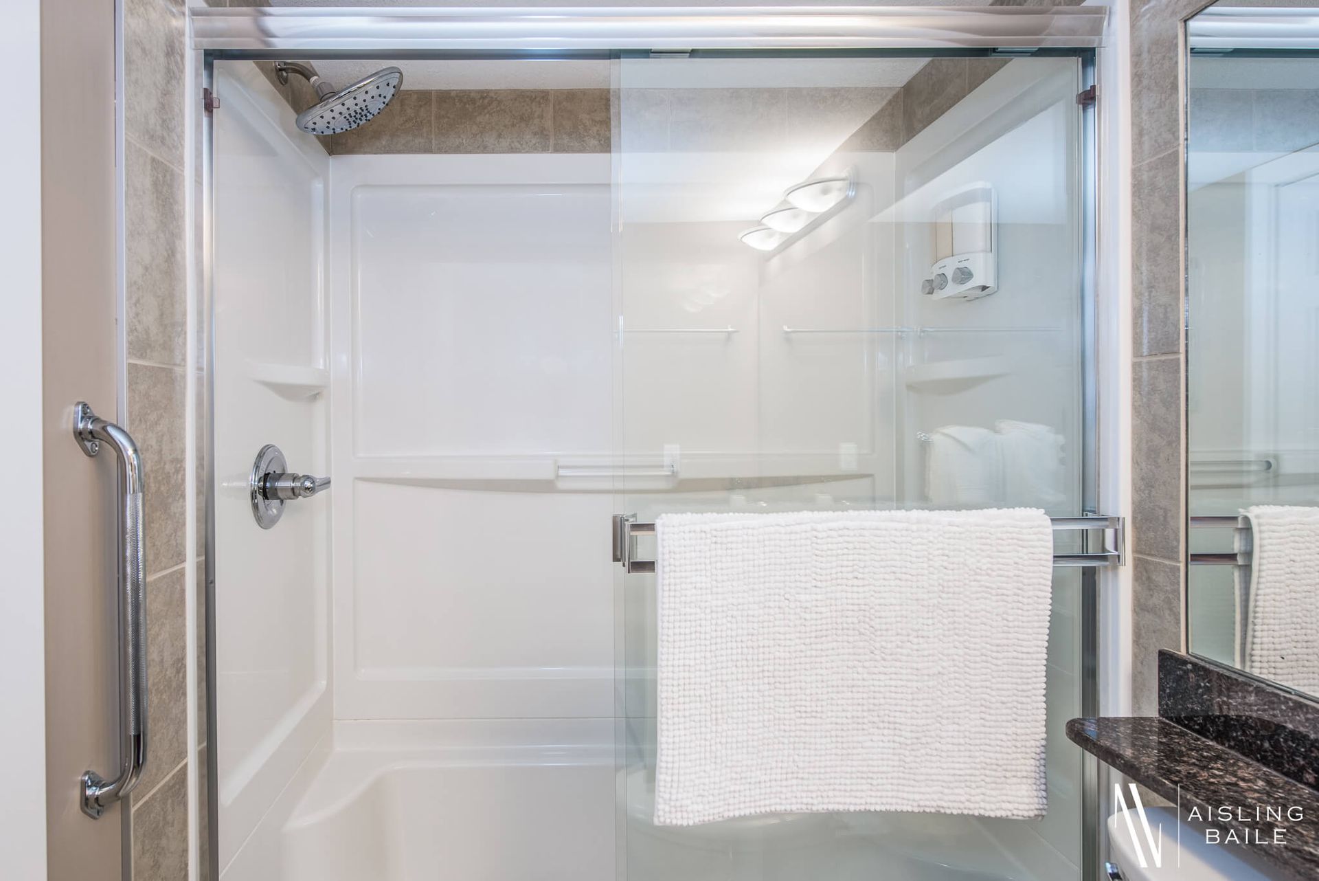 Glass shower door in the full bathroom of the Stylish condo of Lake Windermere Pointe in Invermere, a BC Vacation Rental hosted by Aisling Baile Property Management.