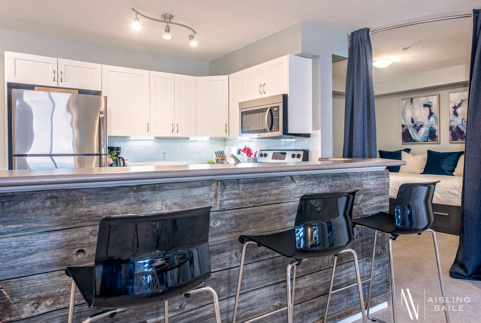 Kitchen island and bar stools at the Trendy condo at Lake Windermere Pointe in Invermere, a BC Vacation Rental hosted by Aisling Baile Property Management.
