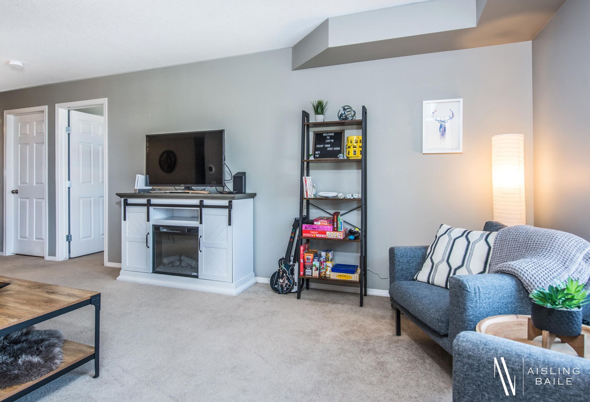 Living room with electric fireplace at the Trendy condo at Lake Windermere Pointe in Invermere, a BC Vacation Rental hosted by Aisling Baile Property Management.
