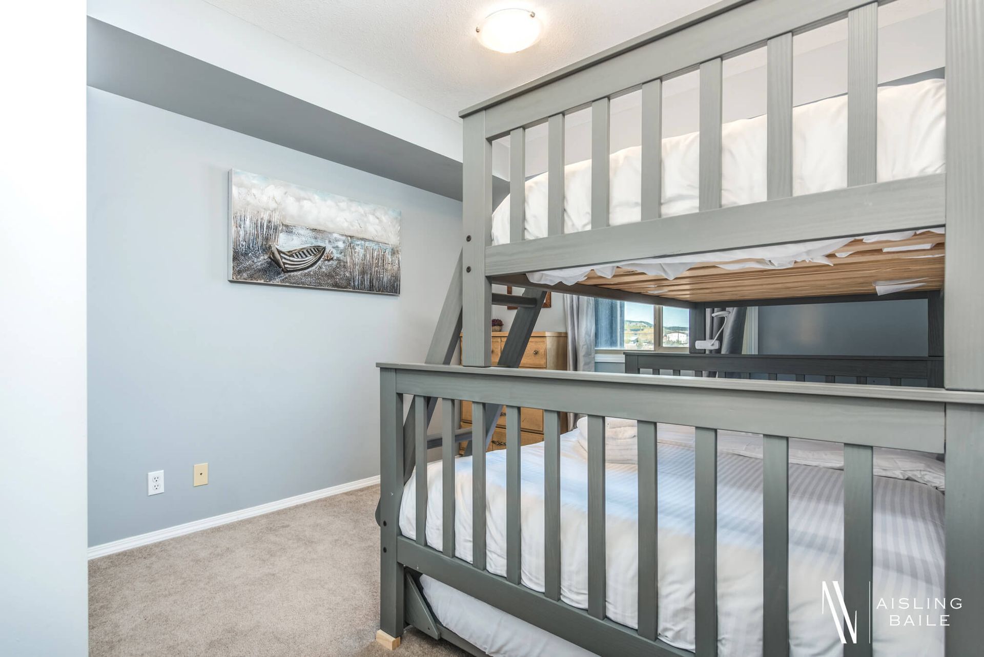 Single-over-double bunk bed at the Trendy condo at Lake Windermere Pointe in Invermere, a BC Vacation Rental hosted by Aisling Baile Property Management.