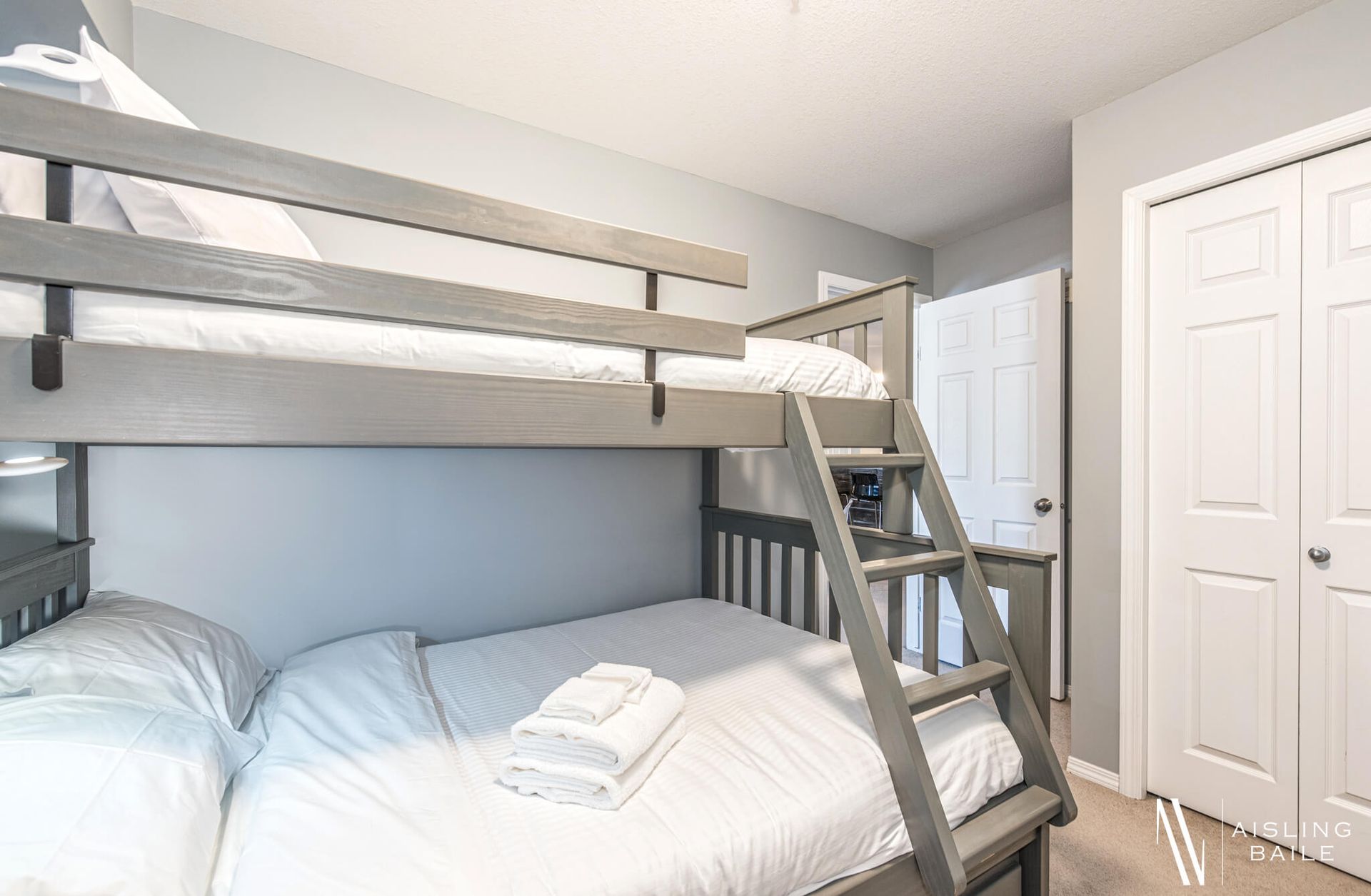 Second bedroom with a single-over-double bunk bed with the Trendy condo at Lake Windermere Pointe in Invermere, a BC Vacation Rental hosted by Aisling Baile Property Management.