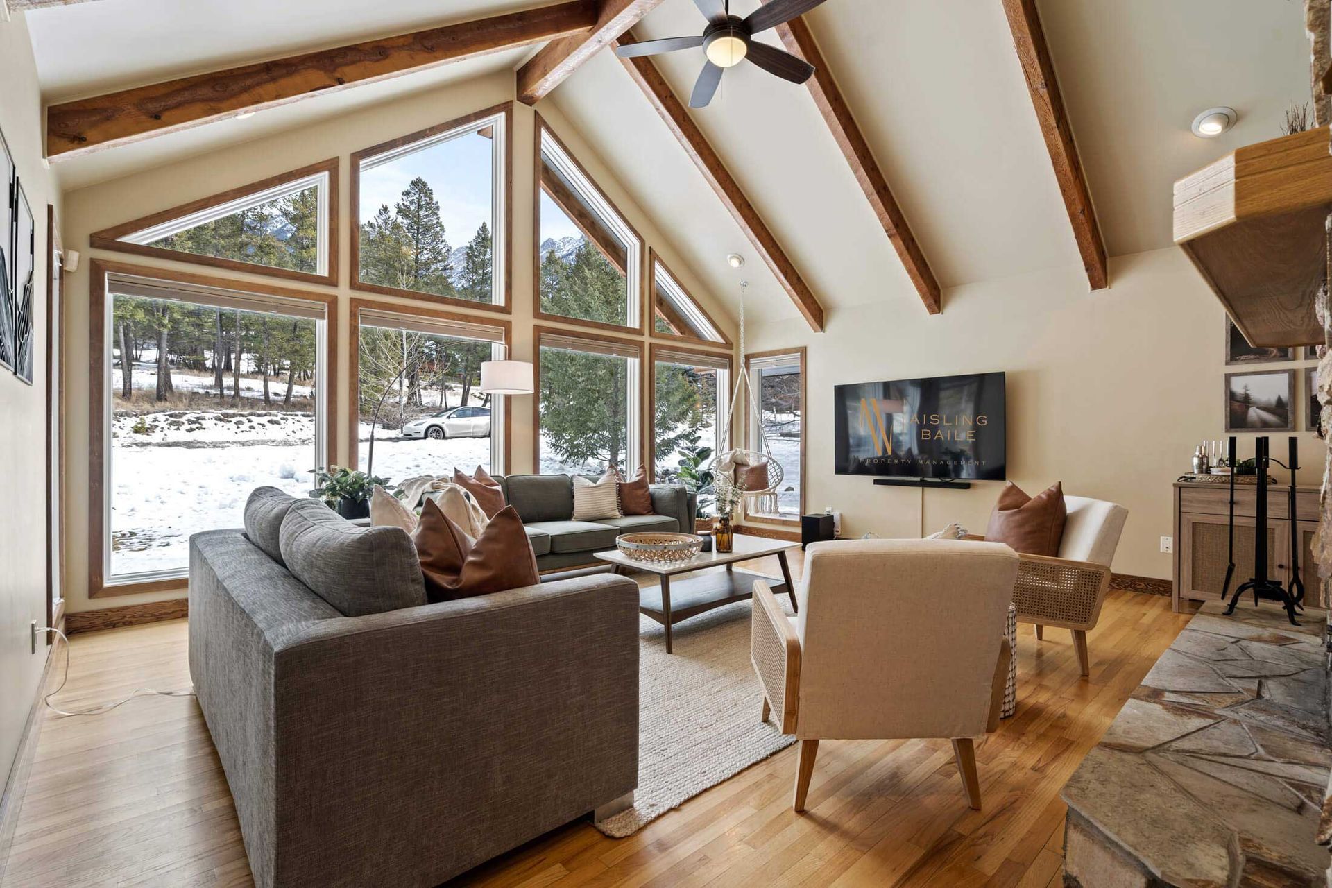 Main floor living room with wood-burning fireplace of Tranquil Pines, a Fairmont Hot Springs BC Vacation Rental hosted by Aisling Baile Property Management.