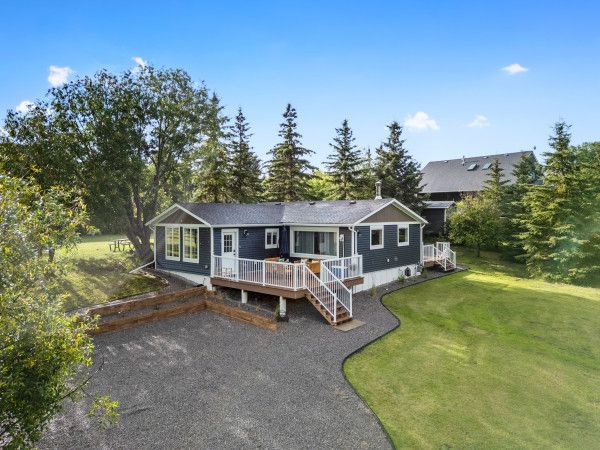 Exterior shot of a home, deck and green space located lakeside of Gull Lake, Alberta.
