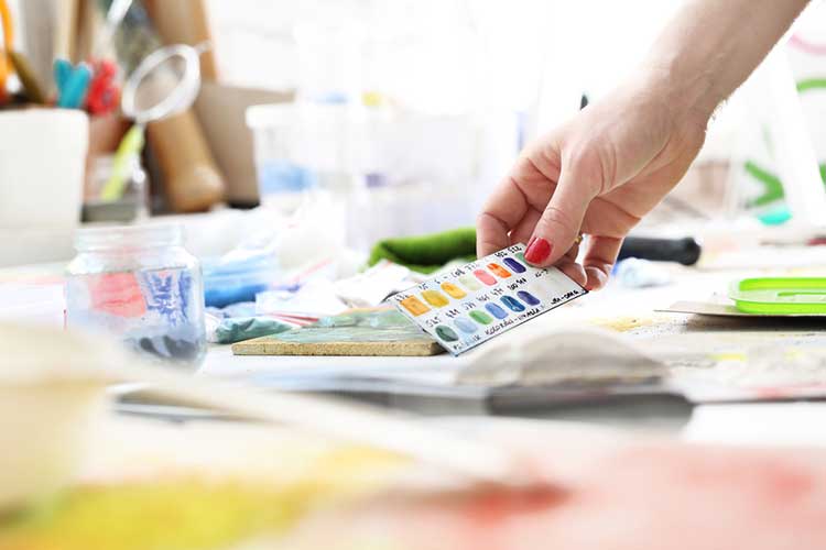 A person is holding a piece of paper on a table.