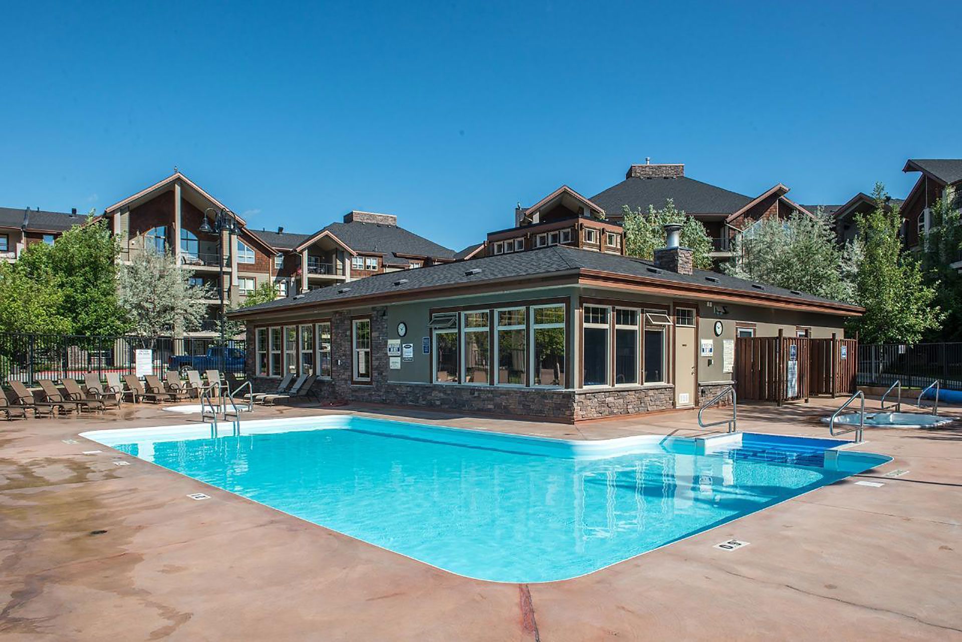 Seasonal outdoor pool and year-round hot tub at the Trendy condo at Lake Windermere Pointe in Invermere, a BC Vacation Rental hosted by Aisling Baile Property Management.