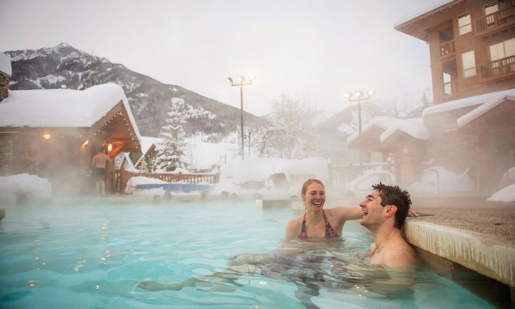 A man and a woman are sitting in a hot tub.