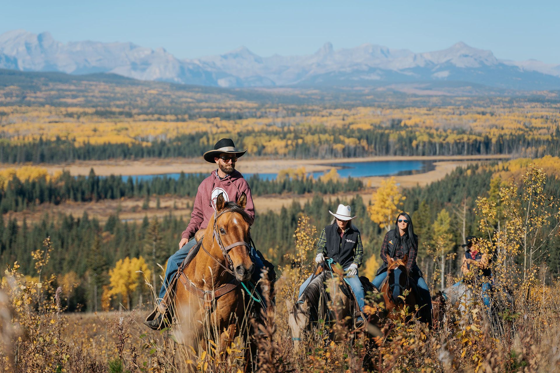 View of 4 people riding through the Cowboy Trail in Cochrane, Alberta.