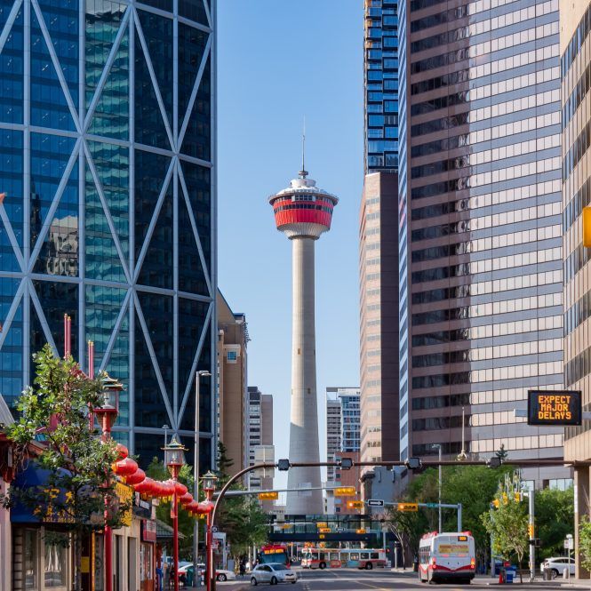 A city street with a clock tower in the middle of it