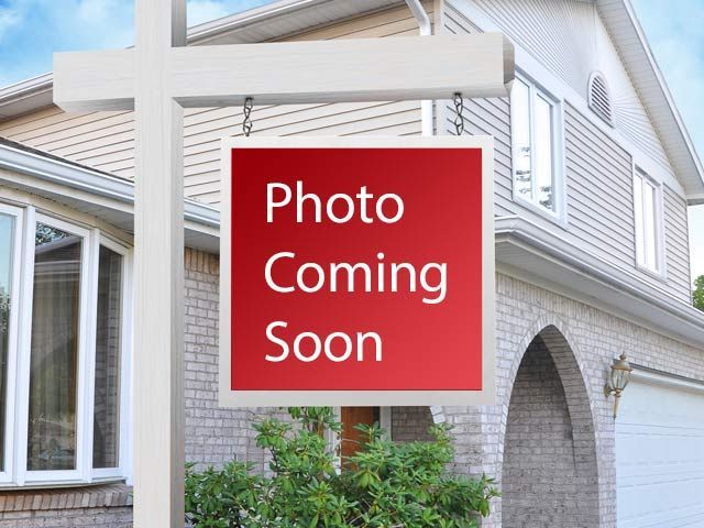 A red sign that says photo coming soon in front of a house
