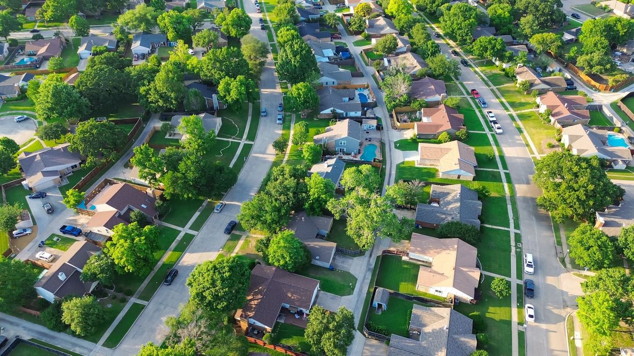 An aerial view of a residential neighborhood filled with lots of houses and trees.