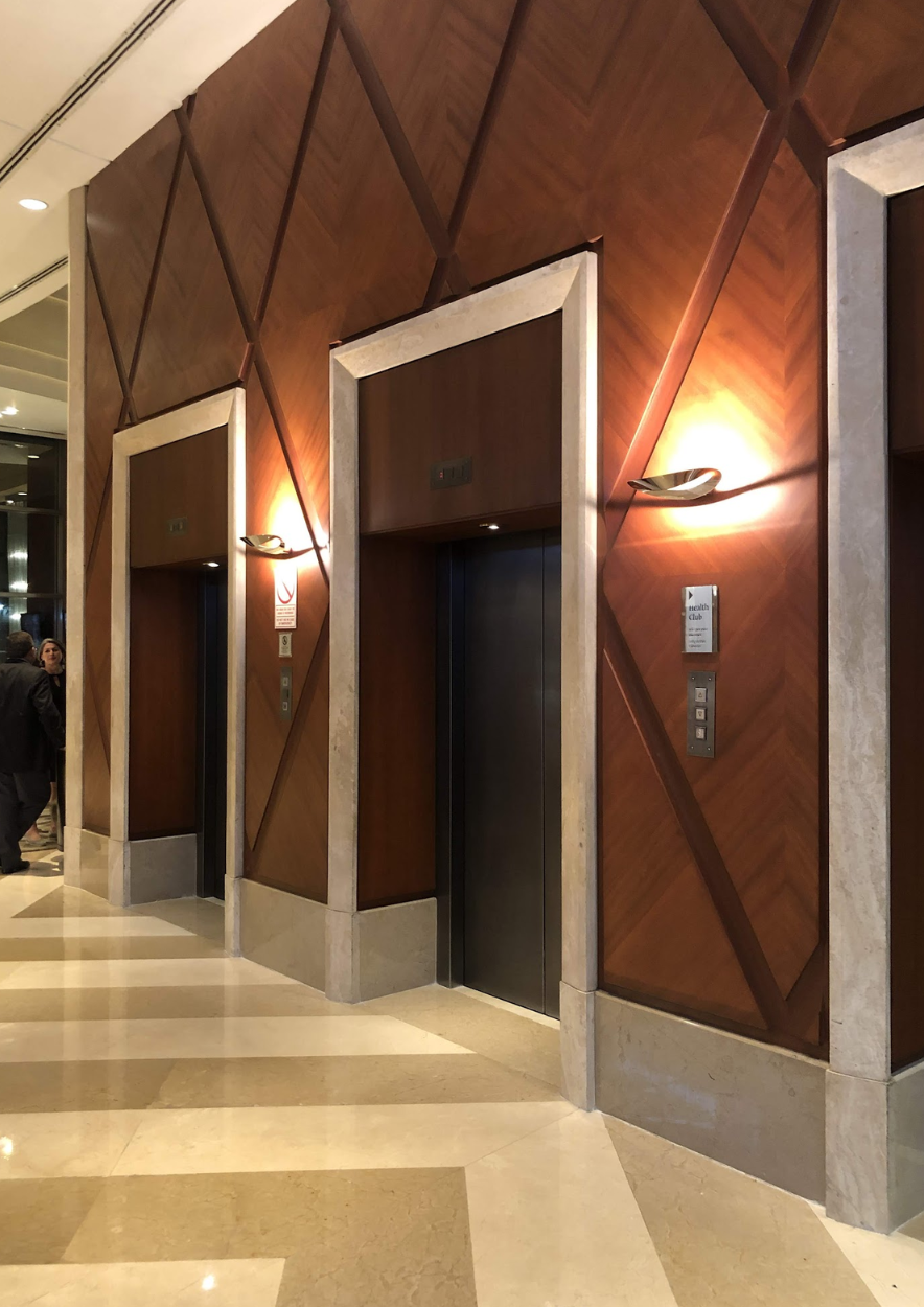 Una fila de ascensores en un edificio con paredes de madera.