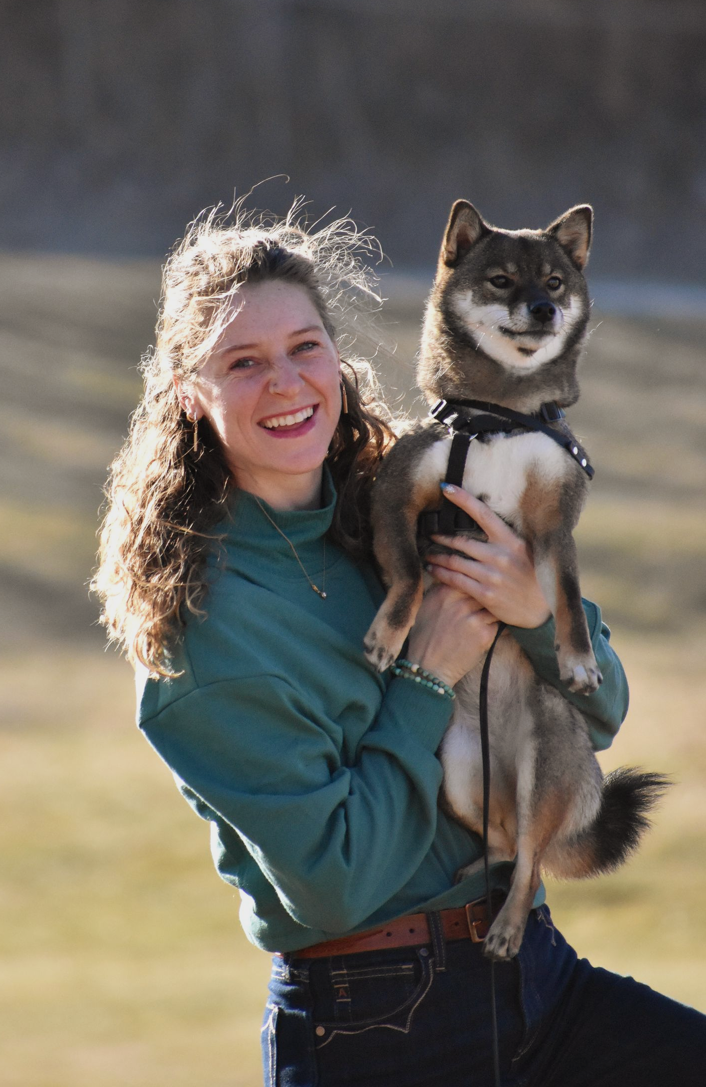 A woman holding a dog.