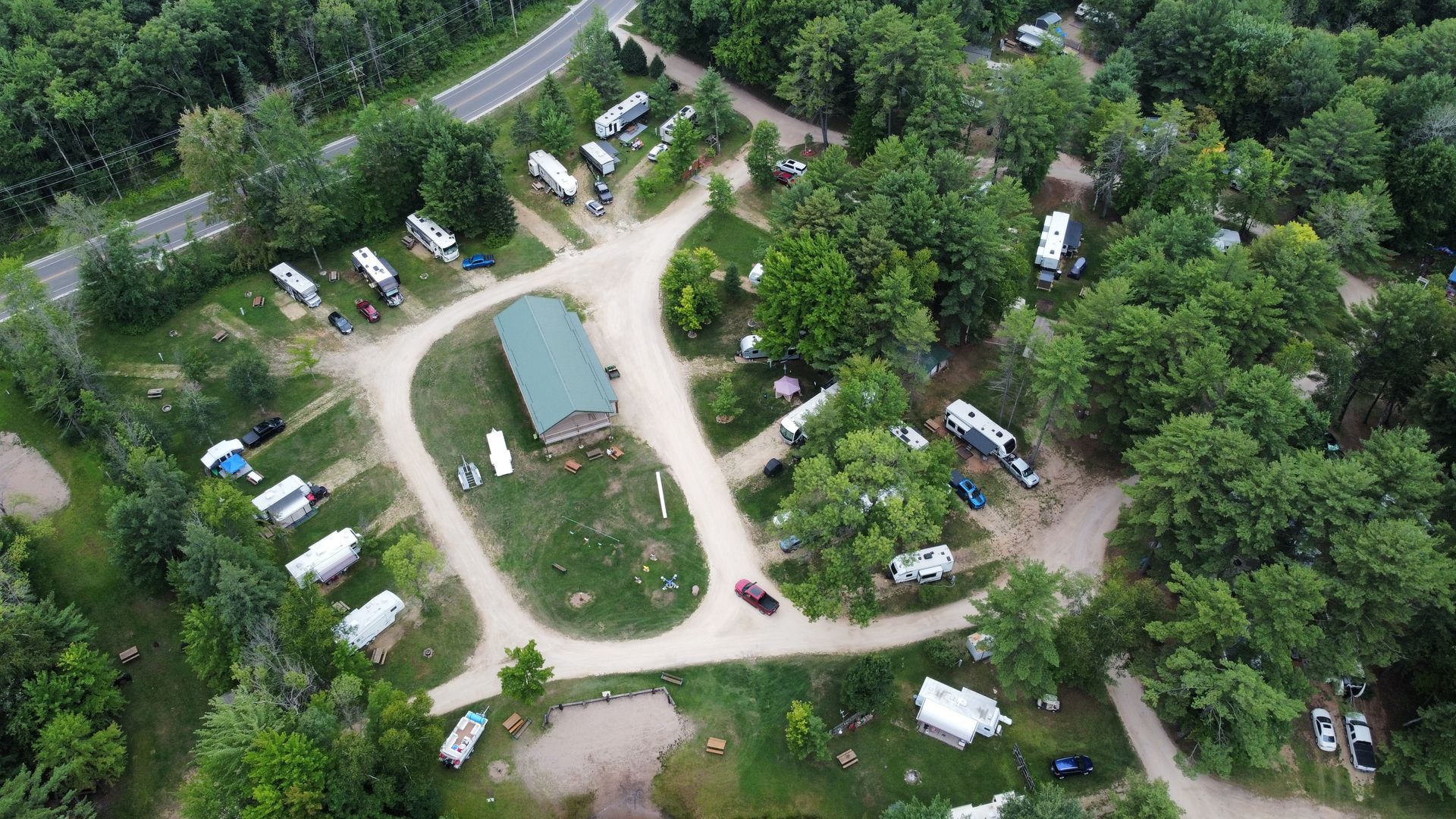 An aerial view of a campground filled with lots of tents and rvs.