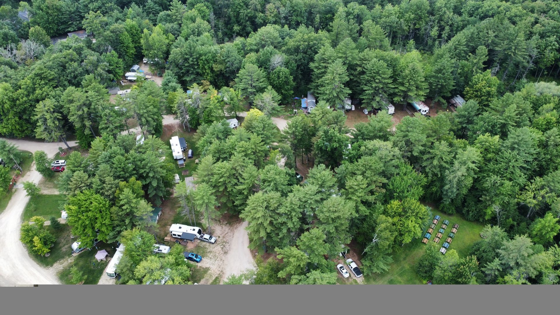An aerial view of a campground surrounded by trees.