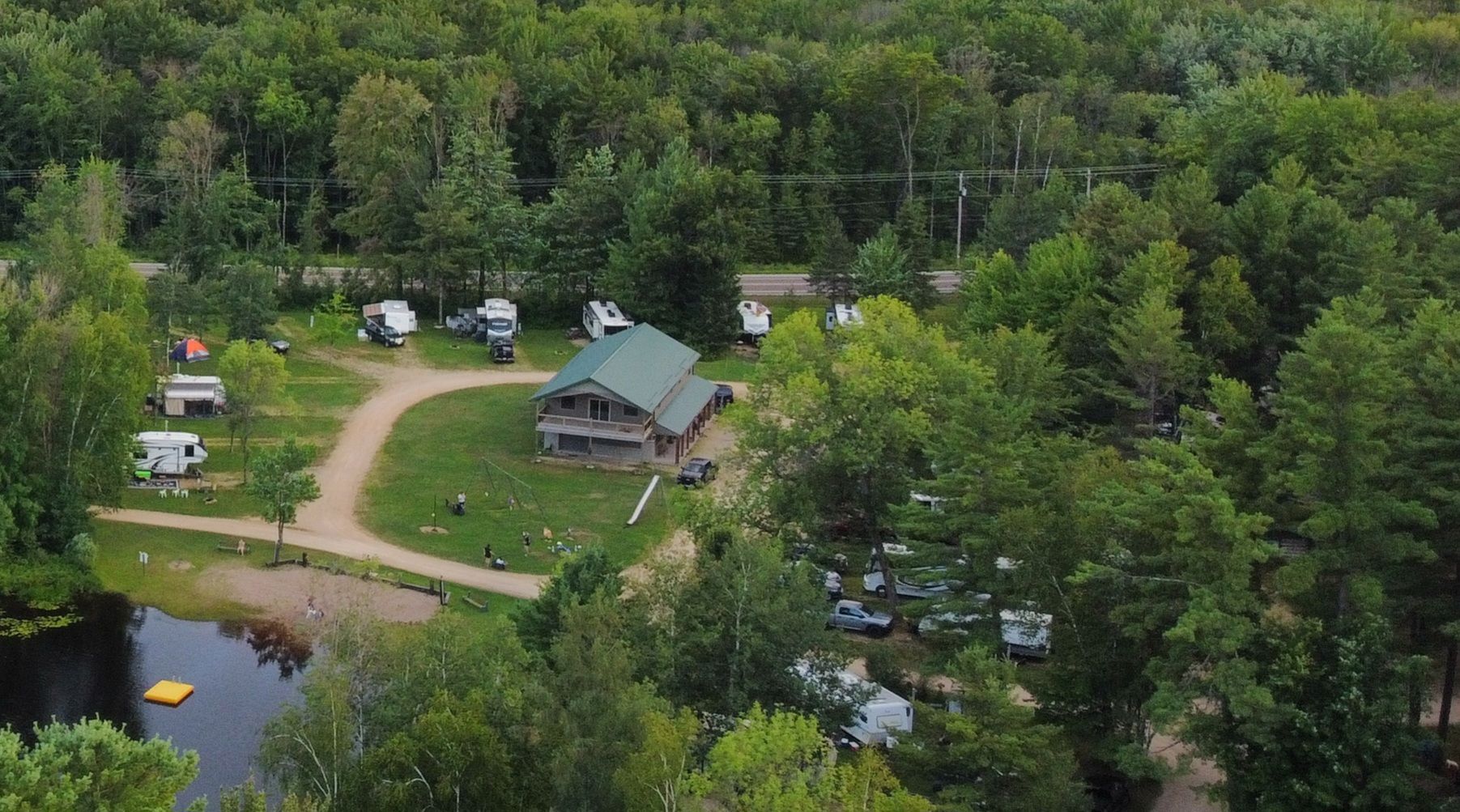 An aerial view of a fawn lake campground surrounded by trees and a lake.