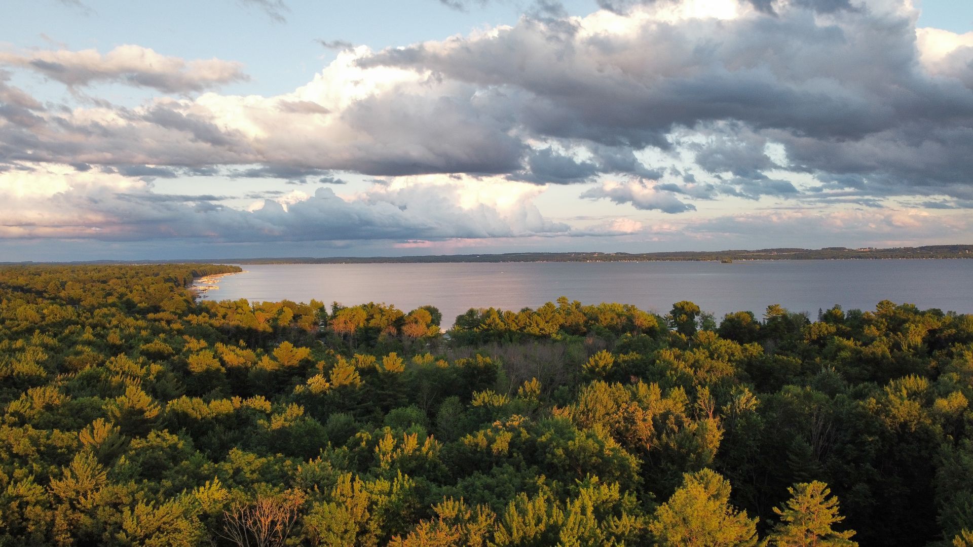 An aerial view of a large body of water surrounded by trees.