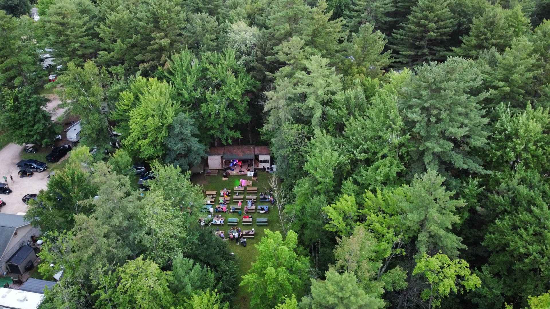 An aerial view of a picnic in the middle of a forest.
