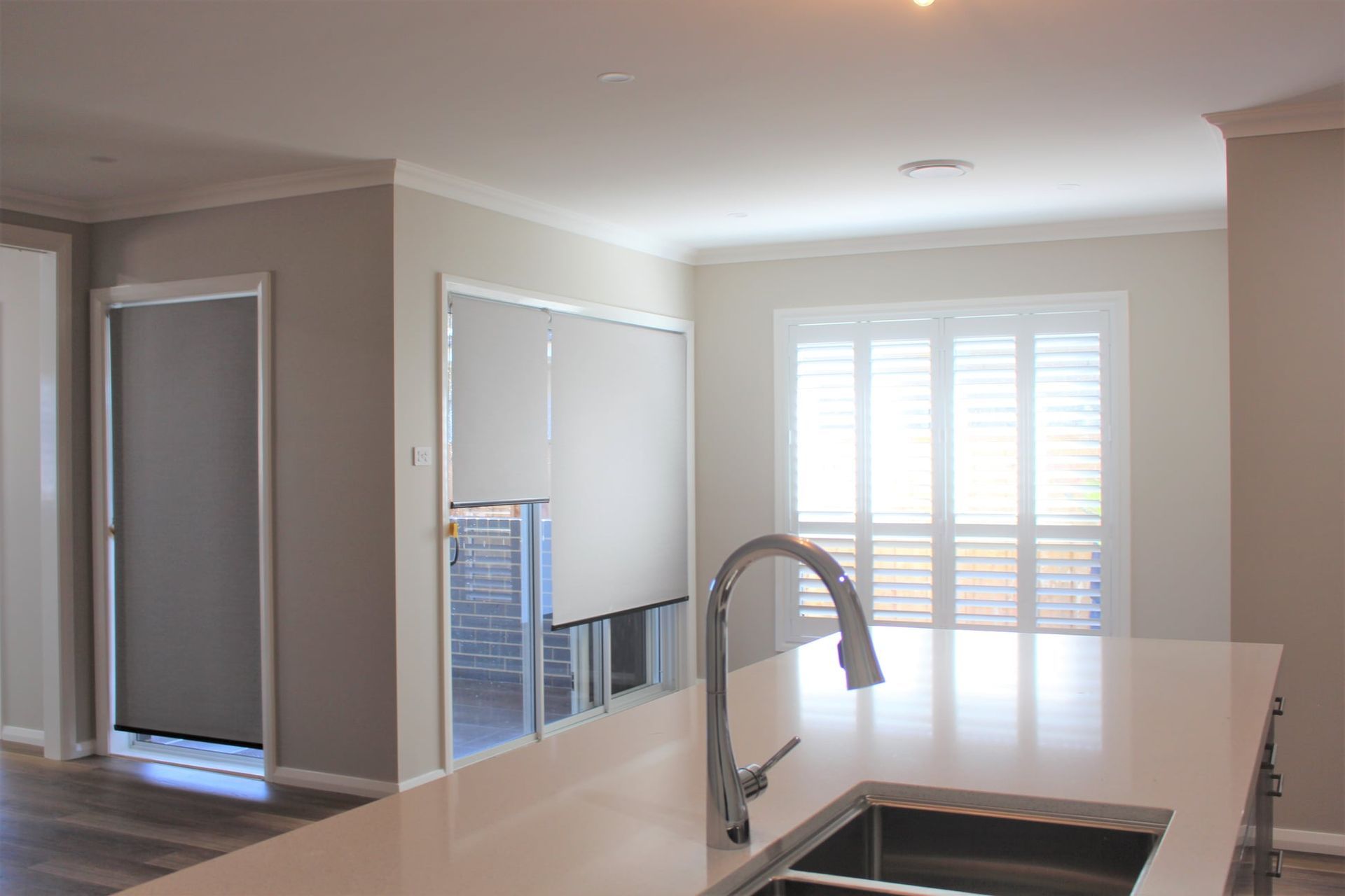 Kitchen With A Sink And A Faucet And Large Window Shutter And Blinds — Maxview Blinds and Shutters in Beresfield, NSW