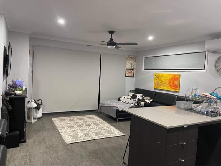 A living room with large motorised blinds — Maxview Blinds and Shutters in Beresfield, NSW