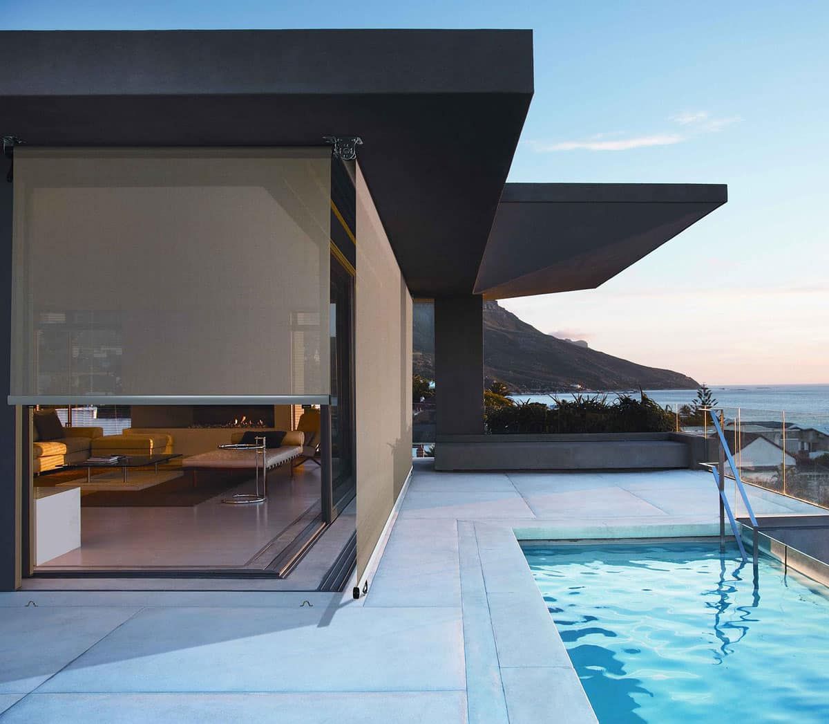 A House With A Large Awning And Swimming Pool In Front Of It — Maxview Blinds and Shutters in Beresfield, NSW