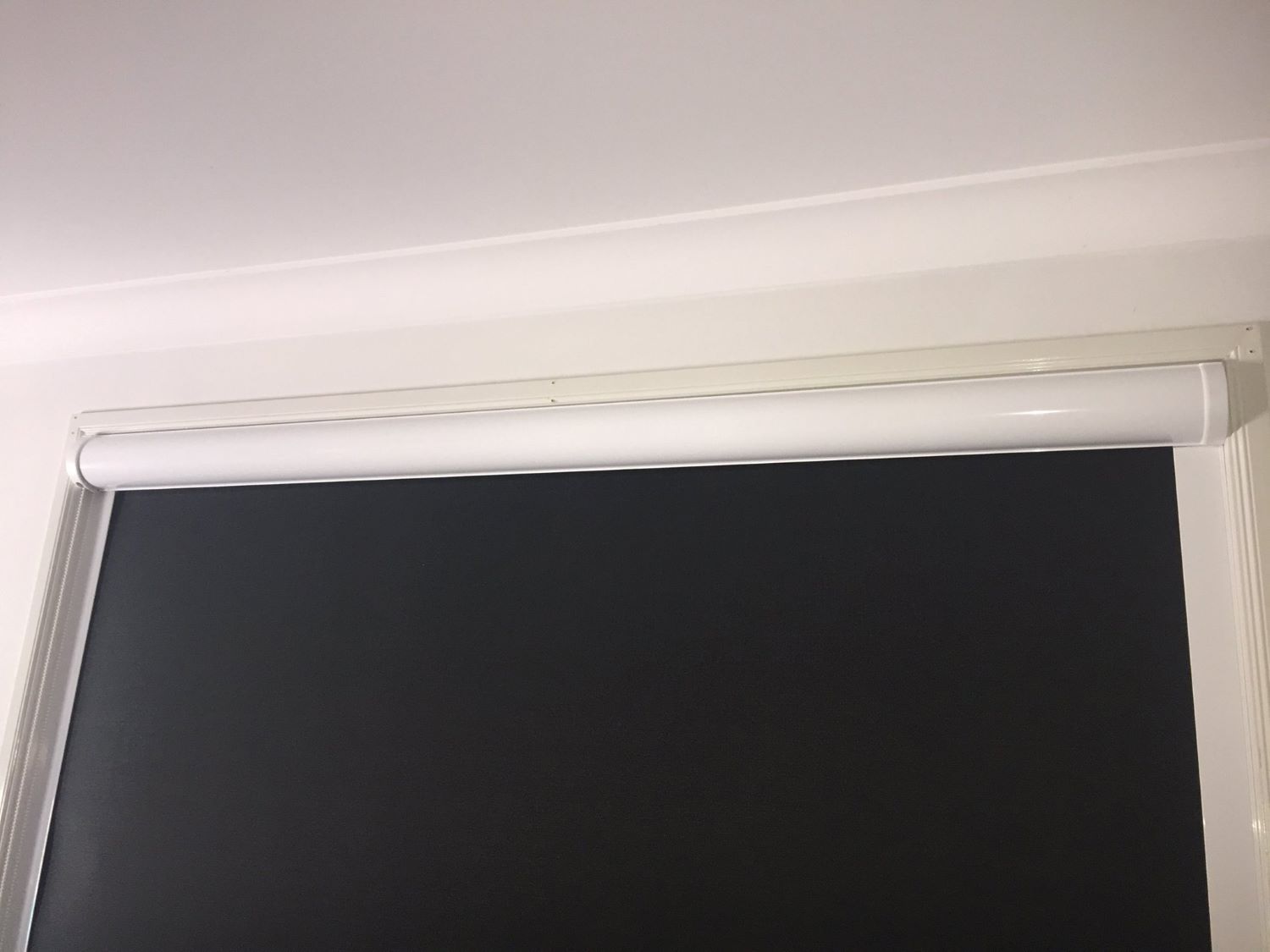 Black Roller Blind On A Window — Maxview Blinds and Shutters in Beresfield, NSW