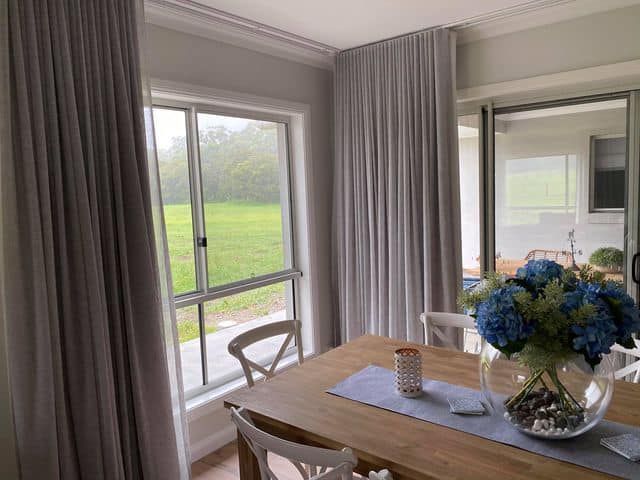 Large Window With Curtains — Maxview Blinds and Shutters in Beresfield, NSW