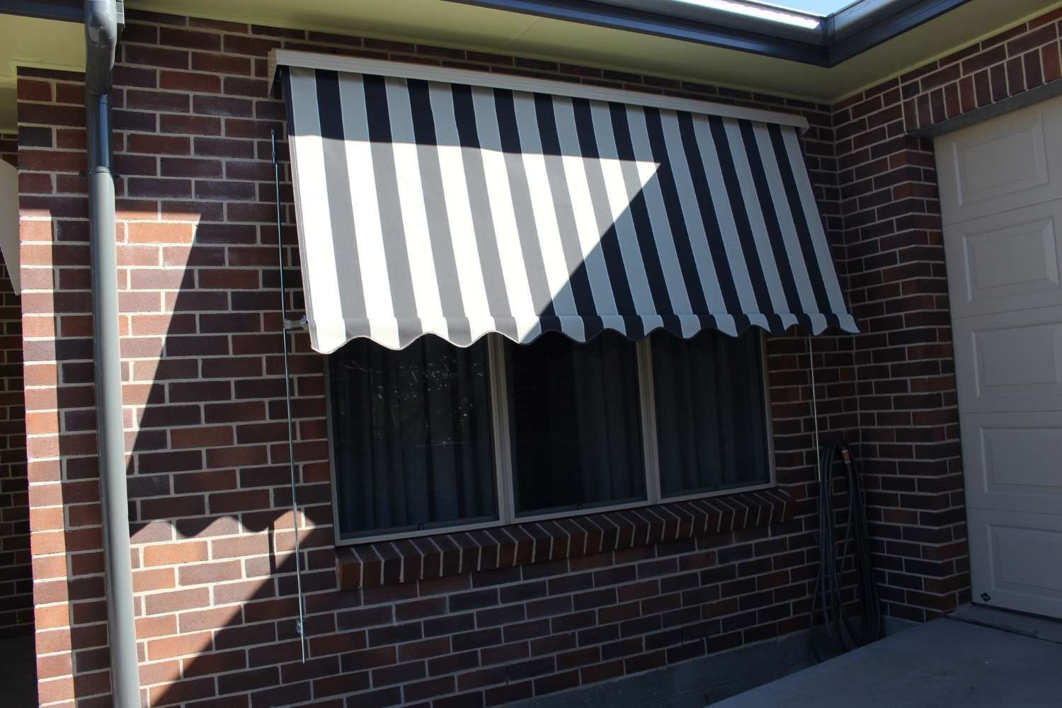 Black And White Striped Awning — Maxview Blinds and Shutters in Beresfield, NSW