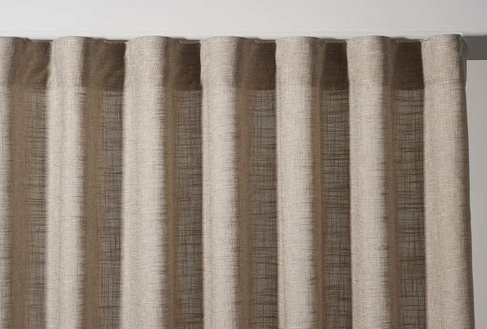 A Close-Up Of A Pair Of Beige Curtains On A White Wall — Maxview Blinds and Shutters in Hunter Valley, NSW