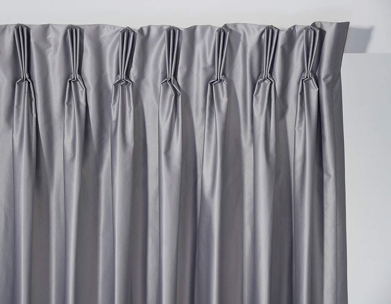 A Pair Of Gray Curtains Are Hanging On A White Wall — Maxview Blinds and Shutters in Beresfield, NSW
