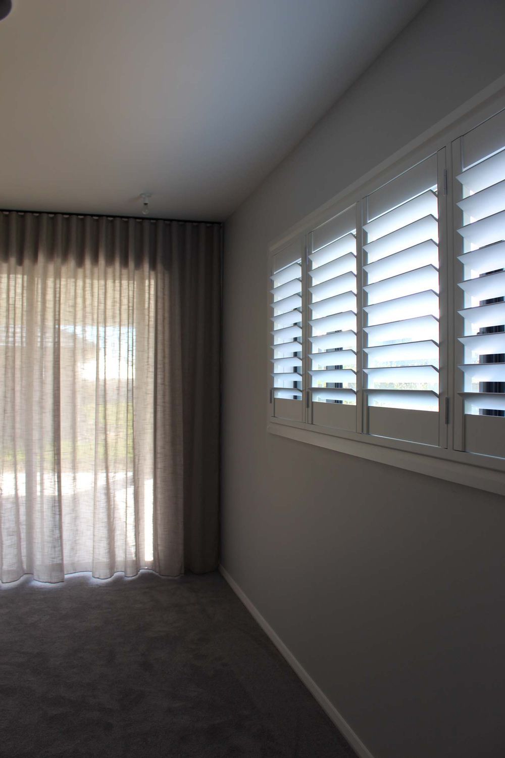Home With Curtains And Shutter On The Window — Maxview Blinds and Shutters in Maitland, NSW