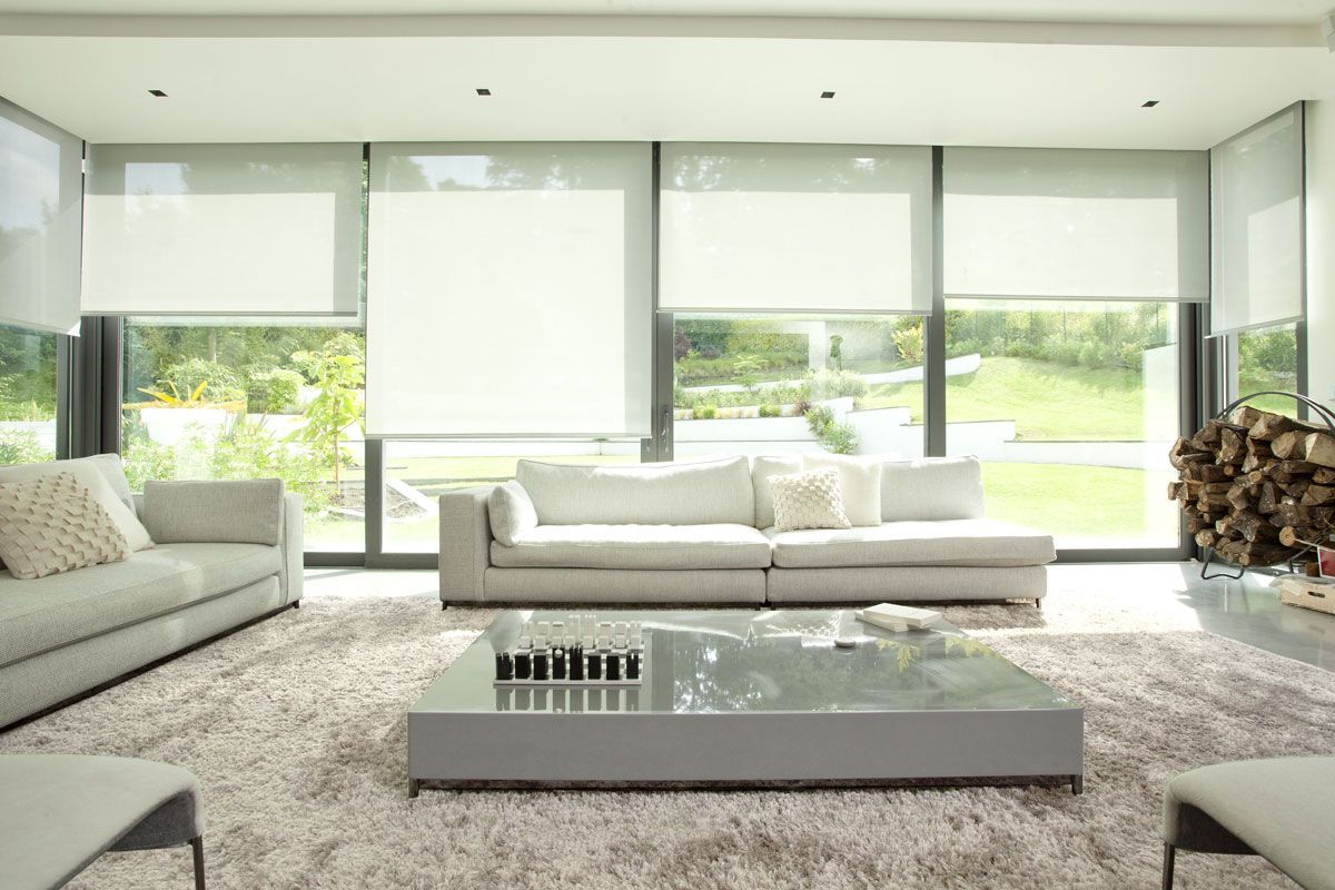 A living room with two couches , a coffee table , and a large window.