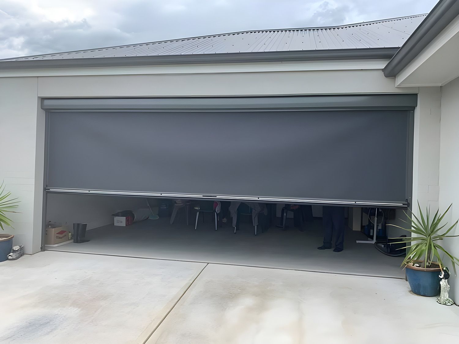 Partially Lowered Gray Awning Covering a Residential Garage