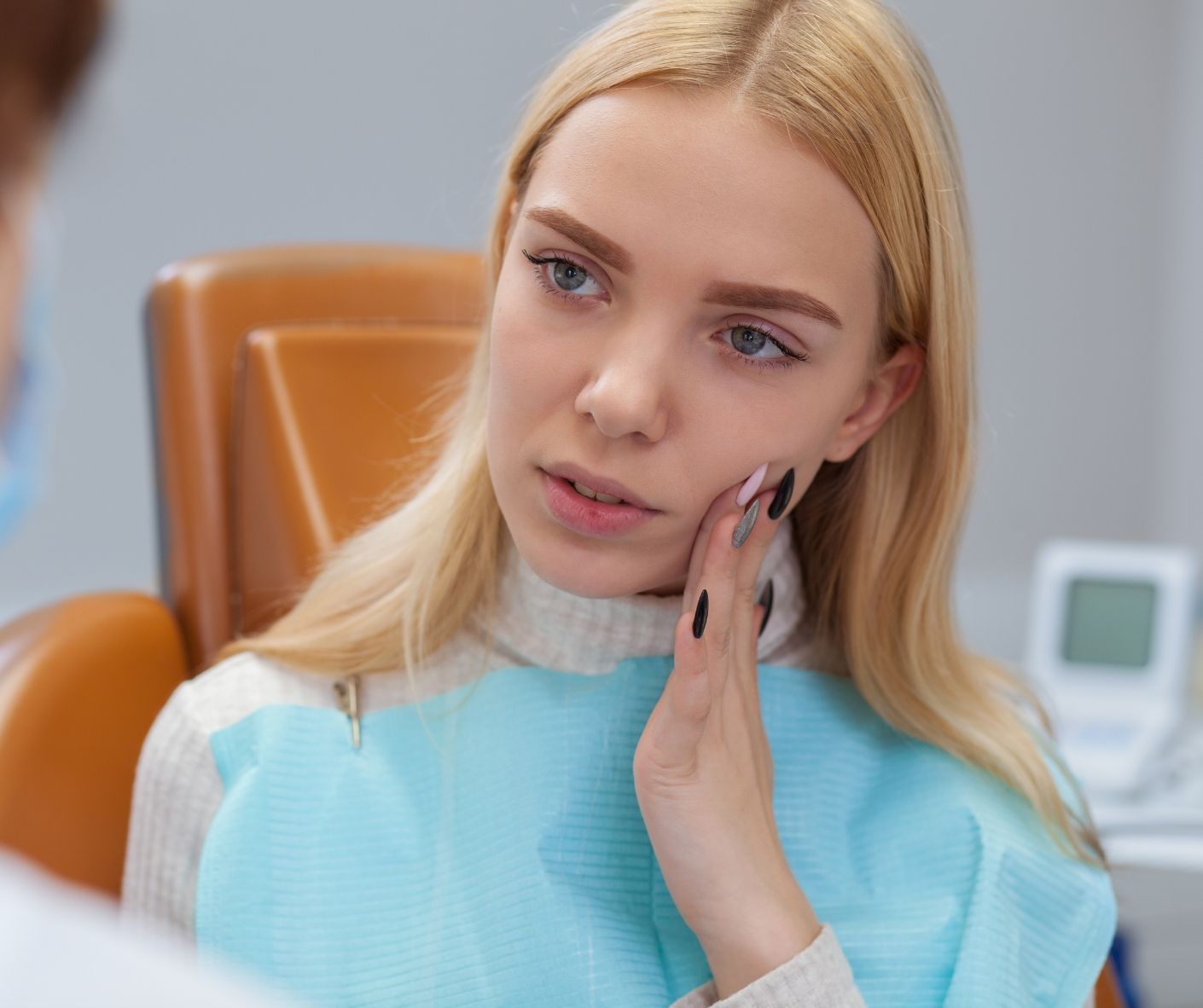 A dentist treating a patient during a dental emergency.