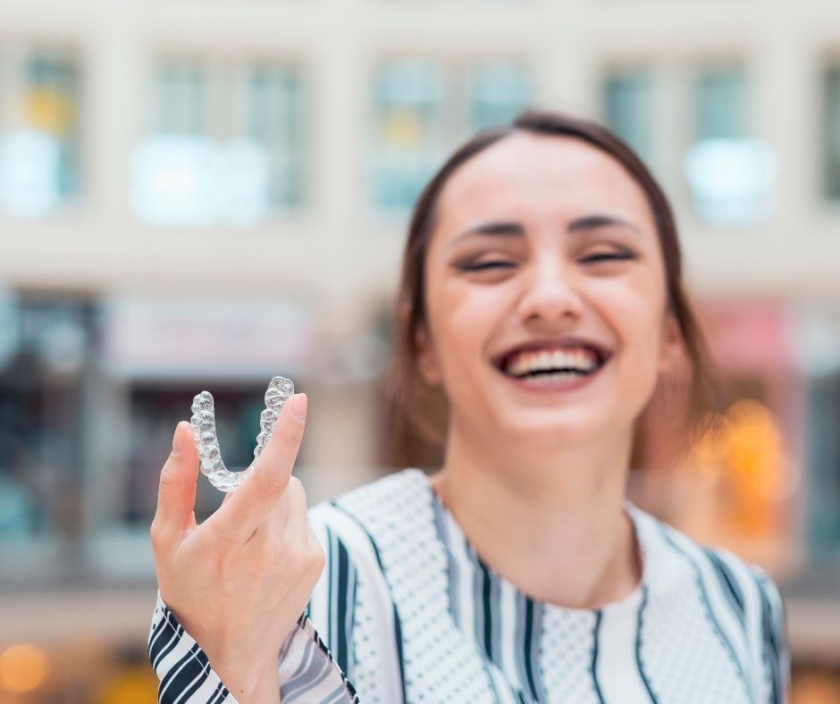 A comparison between Fixed Braces and Invisalign for teeth straightening at a dental practice.