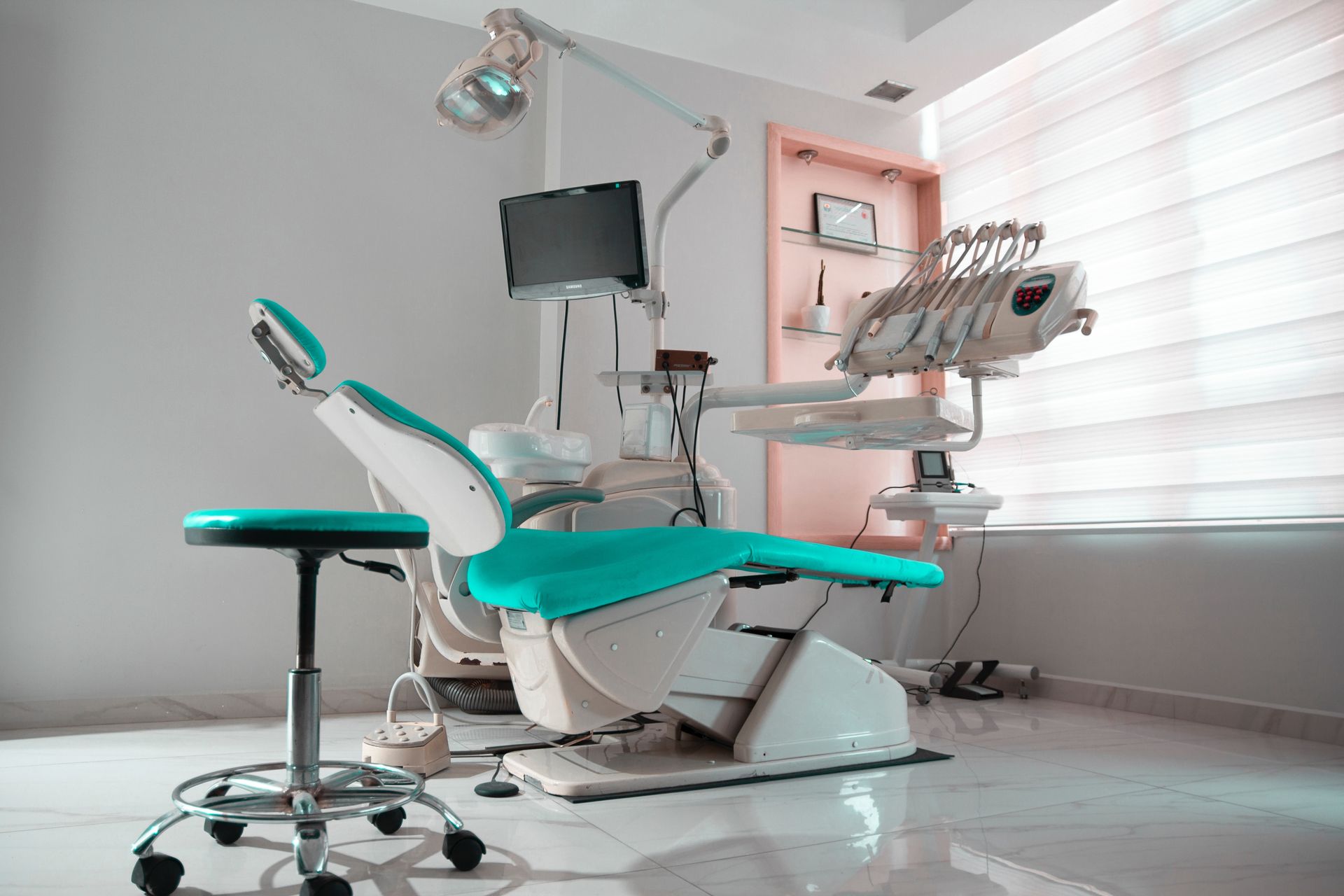 Dental hygienist cleaning a patient’s teeth during a routine appointment.