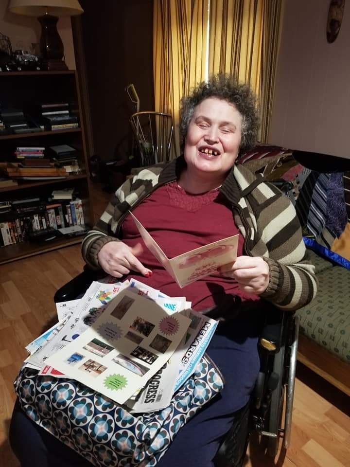 A woman in a wheelchair is reading a book