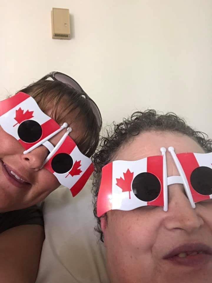 Two women wearing sunglasses with canadian flags on them