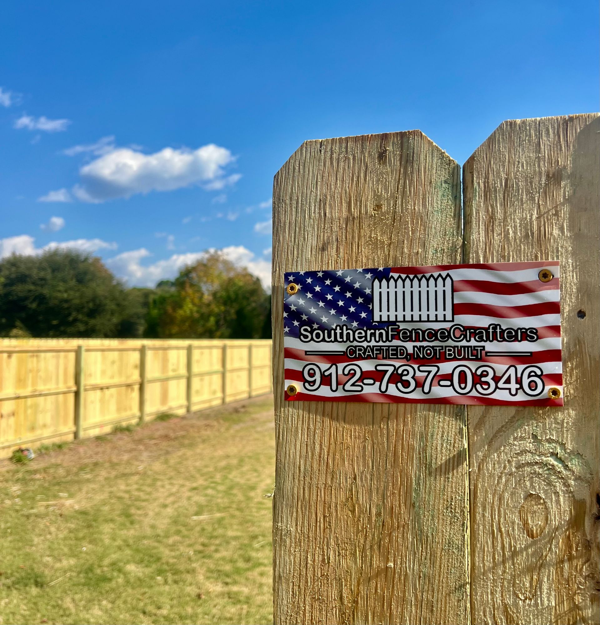 A wooden fence with an american flag on it