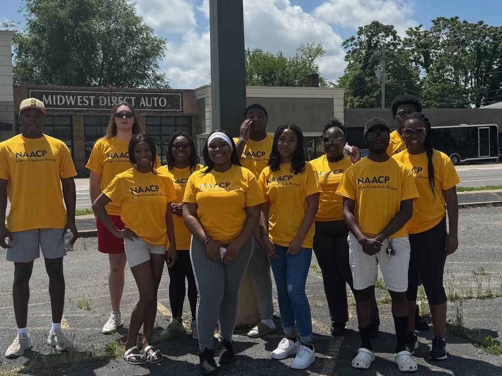 Group of SEMO students in Cape Girardeau NAACP t-shirts posing after canvassing for voter registration.