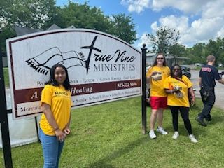 SEMO students pose around a church sign at the community event during canvassing day.