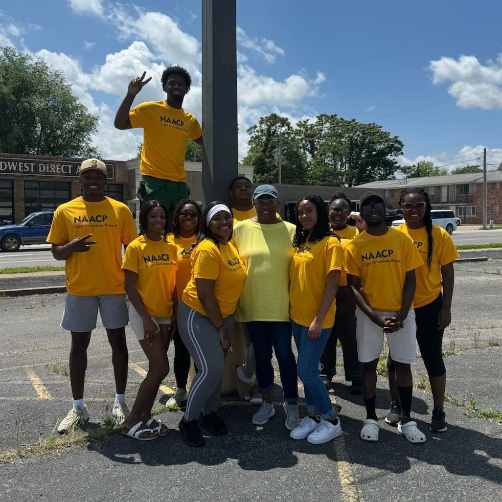 Group of SEMO students in Cape Girardeau NAACP t-shirts posing before beginning to canvass for voter registration.